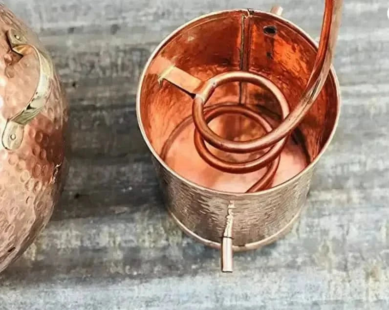 Hand-hammered copper alembic still used for distilling vetiver root at home