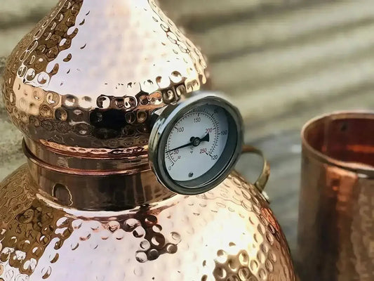 Hand-hammered copper alembic still used for distilling basil water at home